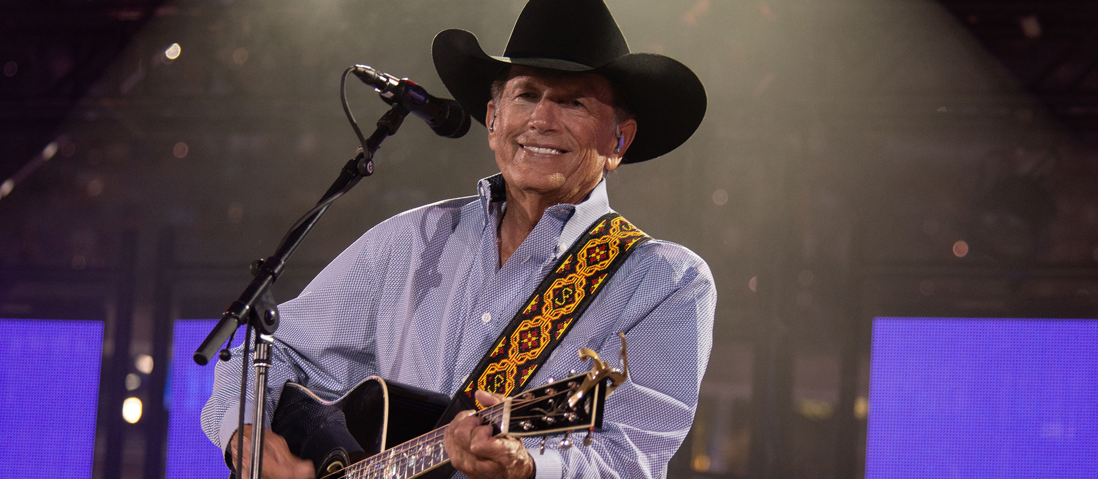 George Strait performing on a stage.